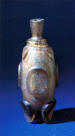 Ointment bottle with oval facets in relief